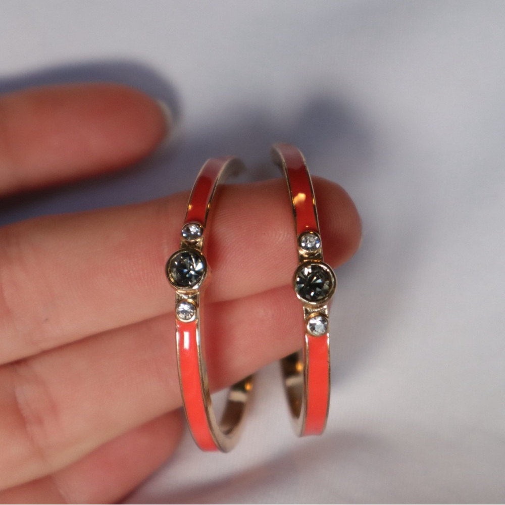 Orange and gold hoop earrings with blue stone accents